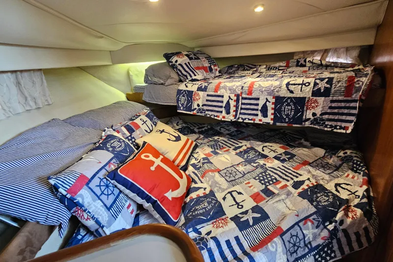 Slide: The Image of Nautical-themed cabin interior of 1995 Carver 355 Aft Cabin Motor Yacht with cozy bedding. - 24