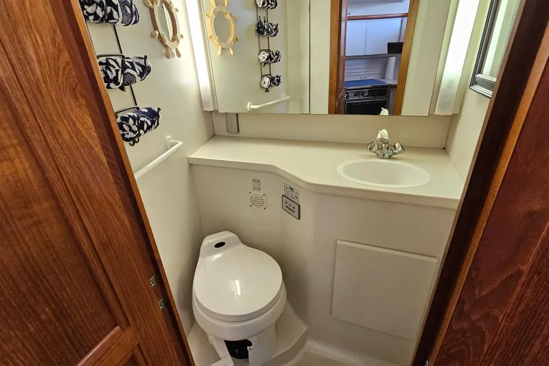 Slide: The Image of Bathroom in 1995 Carver 355 Aft Cabin Motor Yacht with sink and toilet. - 25