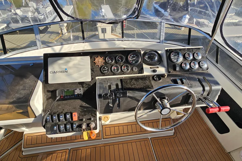 Slide: The Image of 1995 Carver 355 Aft Cabin Motor Yacht helm with Garmin navigation and control panel. - 14