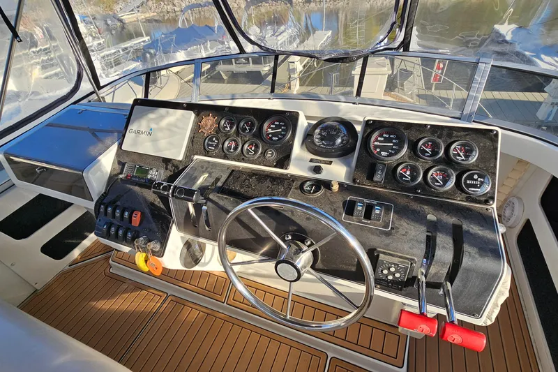 Slide: The Image of 1995 Carver 355 Aft Cabin Motor Yacht helm with Garmin navigation and control gauges. - 15