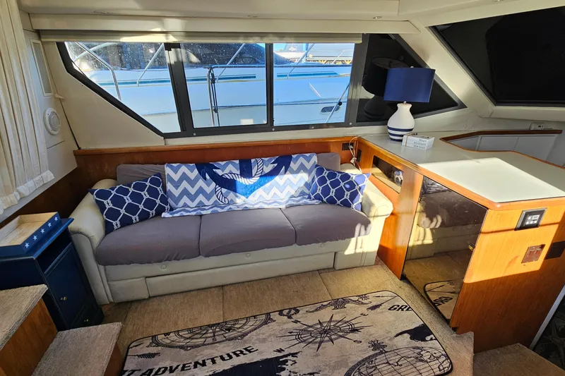 Slide: The Image of Interior of 1995 Carver 355 Aft Cabin Motor Yacht with cozy seating and nautical decor. - 17