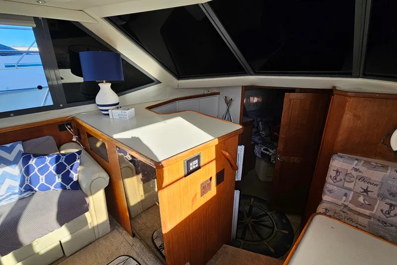 Slide: The Image of 1995 Carver 355 Aft Cabin Motor Yacht interior with cozy seating and nautical decor. - 20
