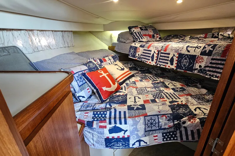 Slide: The Image of Cozy cabin with nautical-themed bedding in 1995 Carver 355 Aft Cabin Motor Yacht. - 23