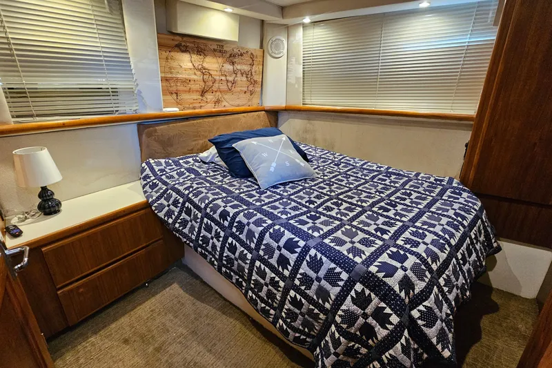 Slide: The Image of Cozy bedroom in 1995 Carver 355 Aft Cabin Motor Yacht with nautical decor. - 26