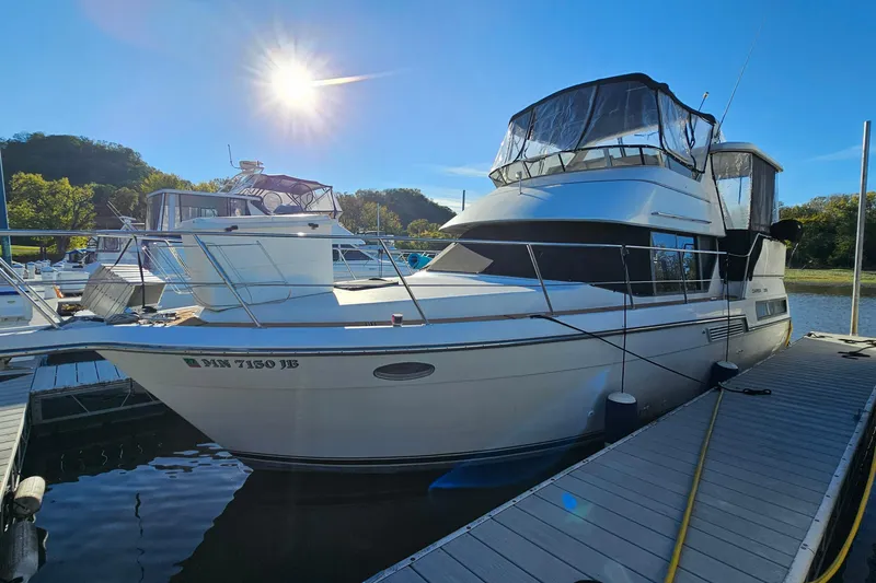 Slide: The Image of 1995 Carver 355 Aft Cabin Motor Yacht docked under bright sun. - 3