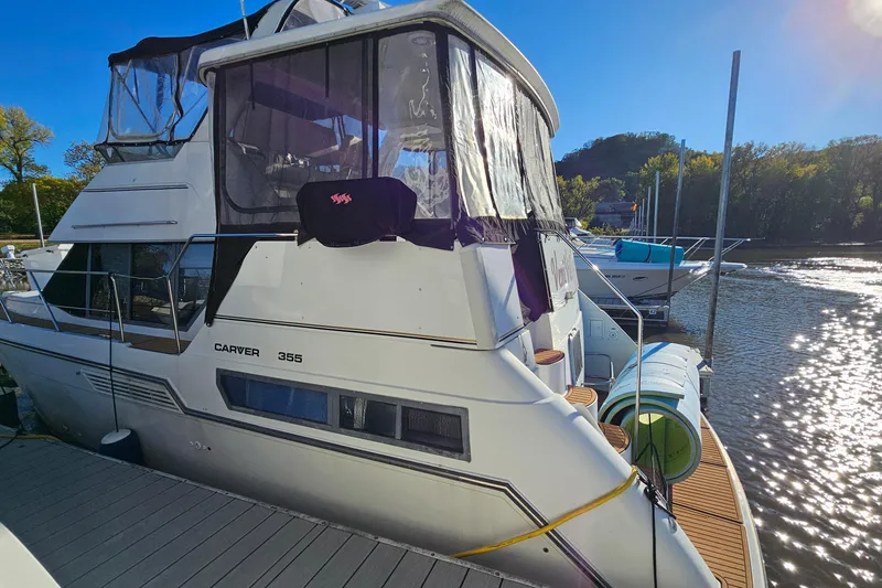 Slide: The Image of 1995 Carver 355 Aft Cabin Motor Yacht docked on a sunny day. - 4