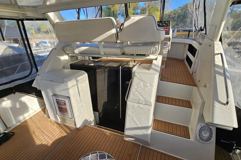 Slide: The Image of 1995 Carver 355 Aft Cabin Motor Yacht interior with seating and wooden flooring. - 8