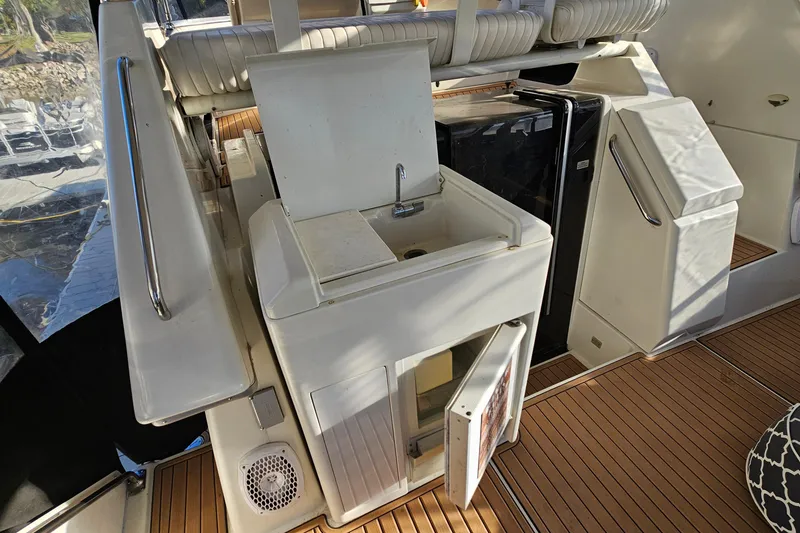 Slide: The Image of 1995 Carver 355 Aft Cabin Motor Yacht interior with sink and seating area. - 9
