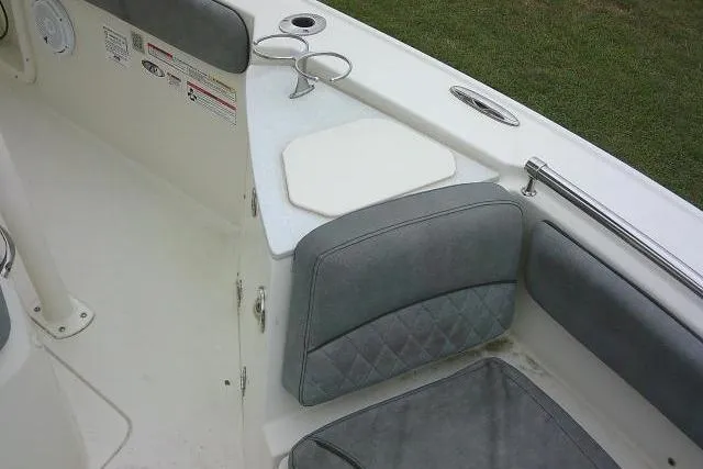Slide: The Image of 2020 Stingray 216 CC boat interior with gray seating and cup holders. - 14