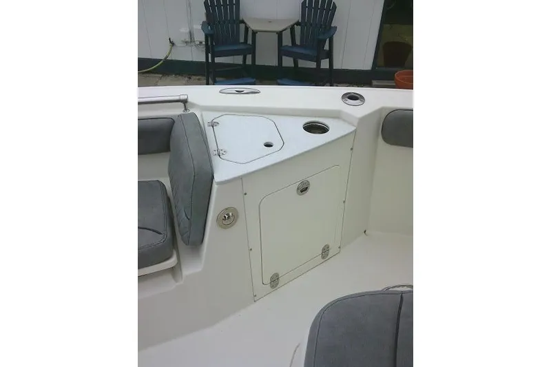 Slide: The Image of 2020 Stingray 216 CC boat interior with seating and storage compartments. - 17