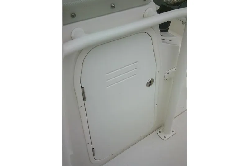 Slide: The Image of White storage compartment door on a 2020 Stingray 216 CC boat. - 19