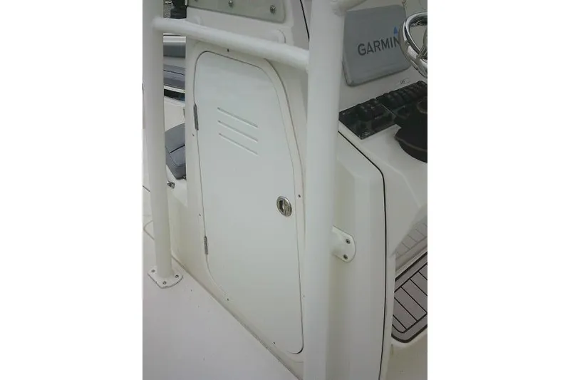 Slide: The Image of 2020 Stingray 216 CC boat console with Garmin navigation system and storage compartment. - 22