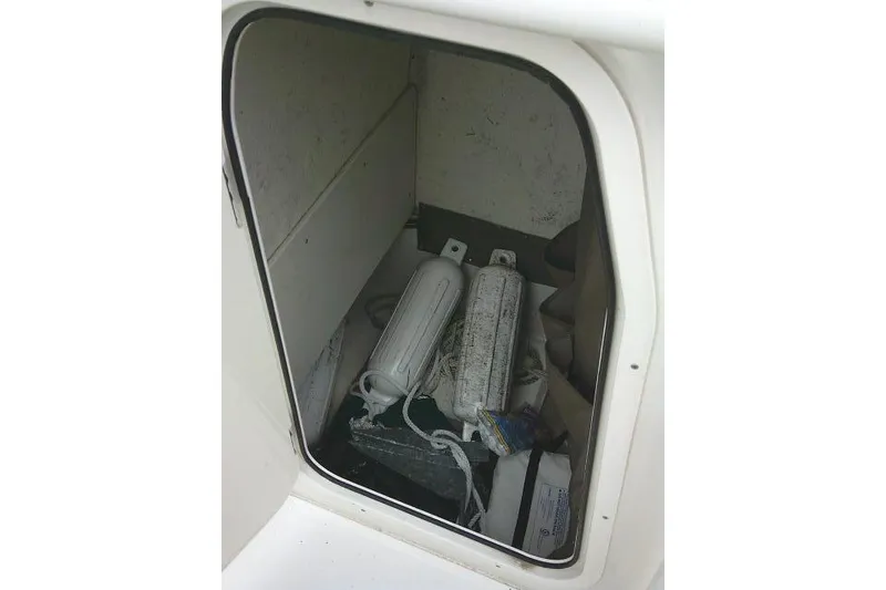 Slide: The Image of Storage compartment of a 2020 Stingray 216 CC boat with fenders and equipment. - 24