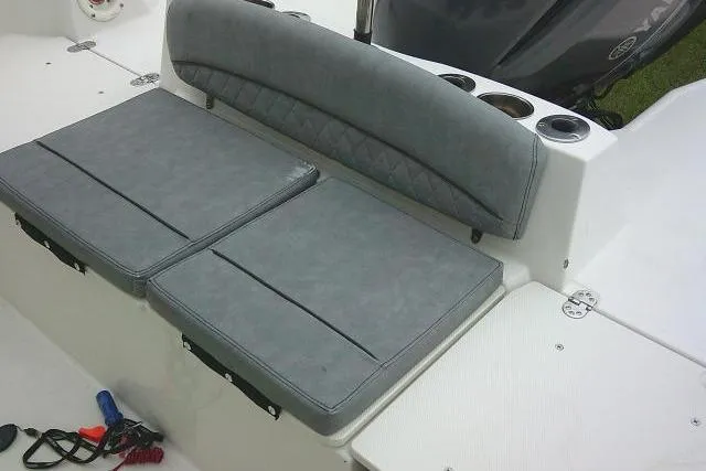 Slide: The Image of 2020 Stingray 216 CC boat with gray cushioned seating and cup holders. - 26