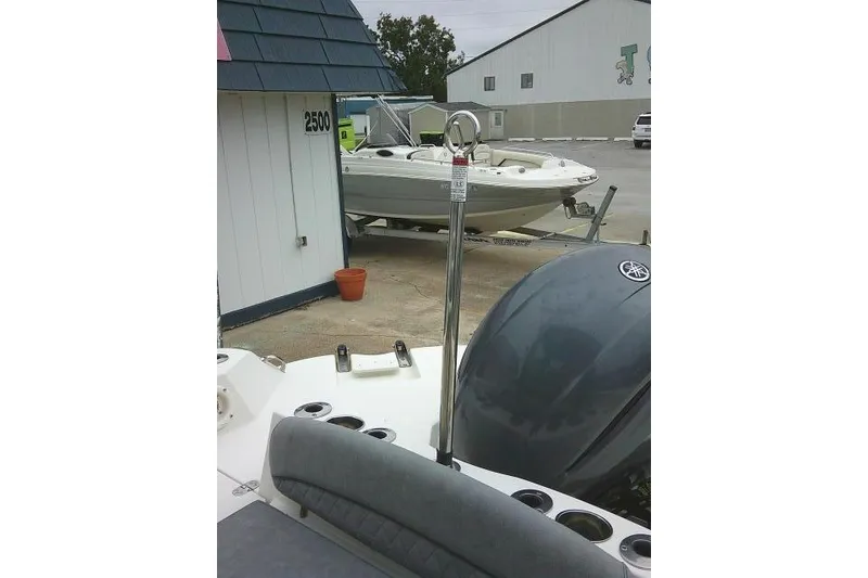 Slide: The Image of 2020 Stingray 216 CC boat with Yamaha engine, parked near a building. - 27