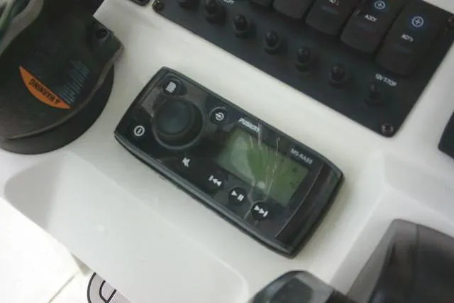 Slide: The Image of Control panel of a 2020 Stingray 216 CC boat with audio system. - 30