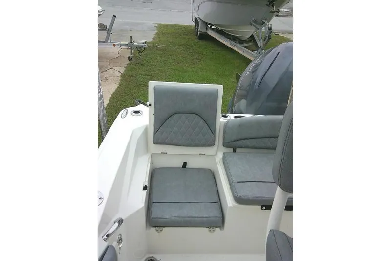 Slide: The Image of 2020 Stingray 216 CC boat interior with gray cushioned seating and cup holders. - 34