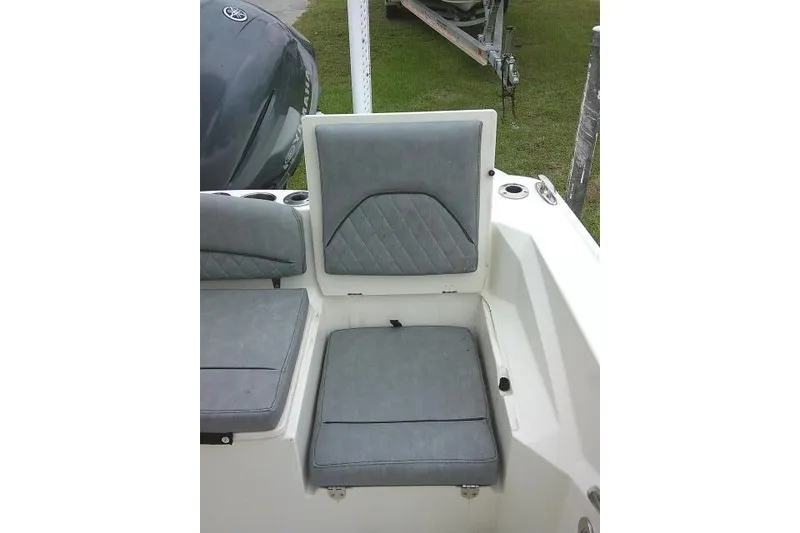 Slide: The Image of 2020 Stingray 216 CC boat with gray cushioned seating and cup holders. - 35