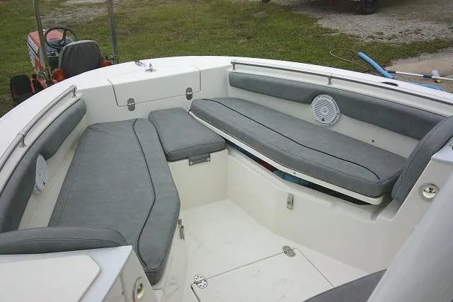 Slide: The Image of 2020 Stingray 216 CC boat interior with gray cushioned seating and storage compartments. - 37