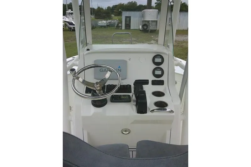 Slide: The Image of 2020 Stingray 216 CC boat console with steering wheel, gauges, and Garmin navigation system. - 40