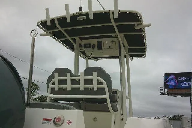 Slide: The Image of 2020 Stingray 216 CC boat with T-top and dual seats, overcast sky background. - 5