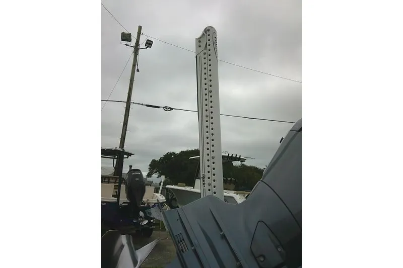 Slide: The Image of 2020 Stingray 216 CC boat with Power-Pole anchor against cloudy sky. - 6