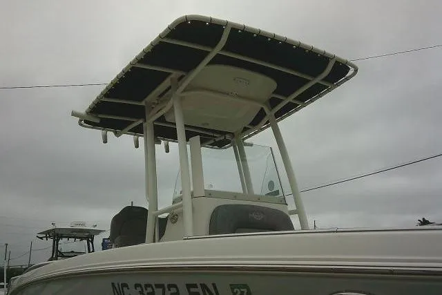 Slide: The Image of 2020 Stingray 216 CC boat with T-top under cloudy sky. - 9