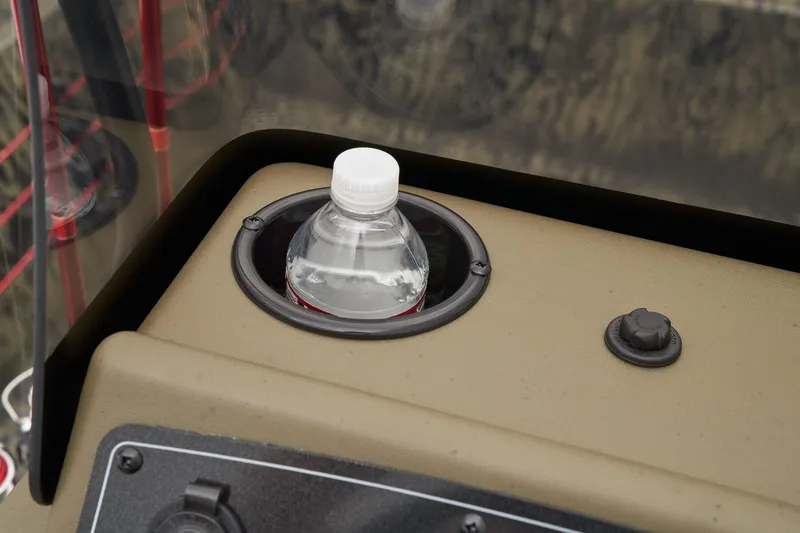 Slide: The Image of Manufacturer Provided Image: Cup holder with water bottle on 2026 Tracker Grizzly 1860 CC boat console. - 23