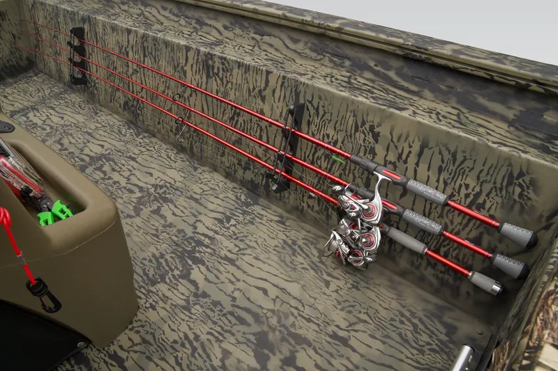 Slide: The Image of Manufacturer Provided Image: Fishing rods secured on 2026 Tracker Grizzly 1860 CC boat with camo interior design. - 27