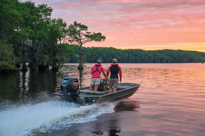 Slide: The Image of Manufacturer Provided Image: 2026 Tracker Grizzly 1860 CC boat cruising on a serene lake at sunset. - 41