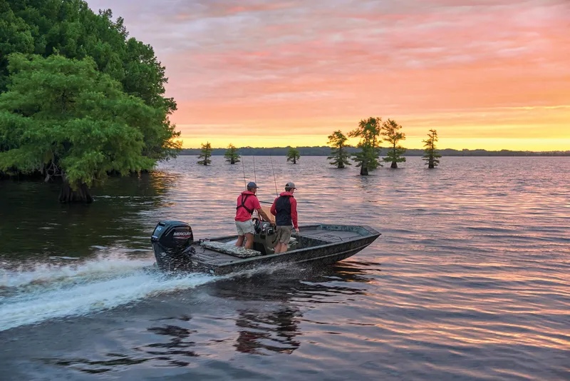 Slide: The Image of Manufacturer Provided Image: 2026 Tracker Grizzly 1860 CC boat cruising on a lake at sunset. - 42