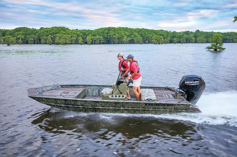 Slide: The Image of Manufacturer Provided Image: 2026 Tracker Grizzly 1860 CC boat cruising on a scenic lake with two passengers. - 49