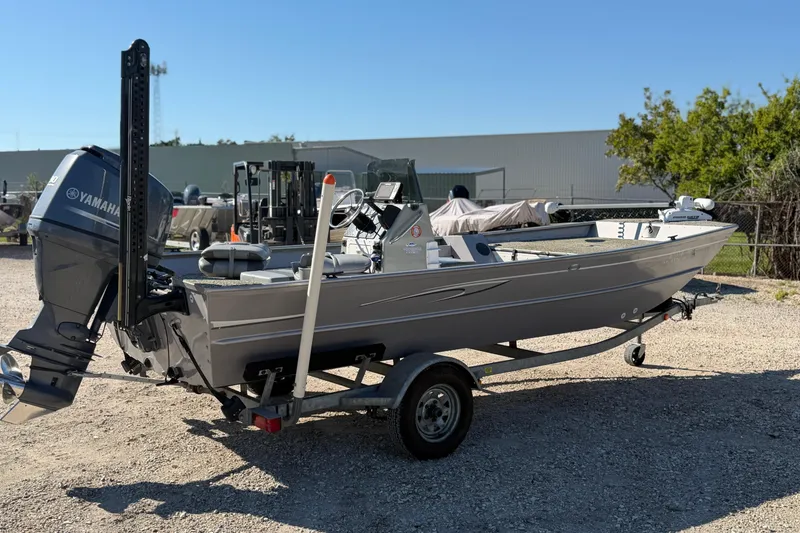 Slide: The Image of 2013 G3 1860 CC Deluxe boat with Yamaha motor on a trailer, parked outdoors. - 10