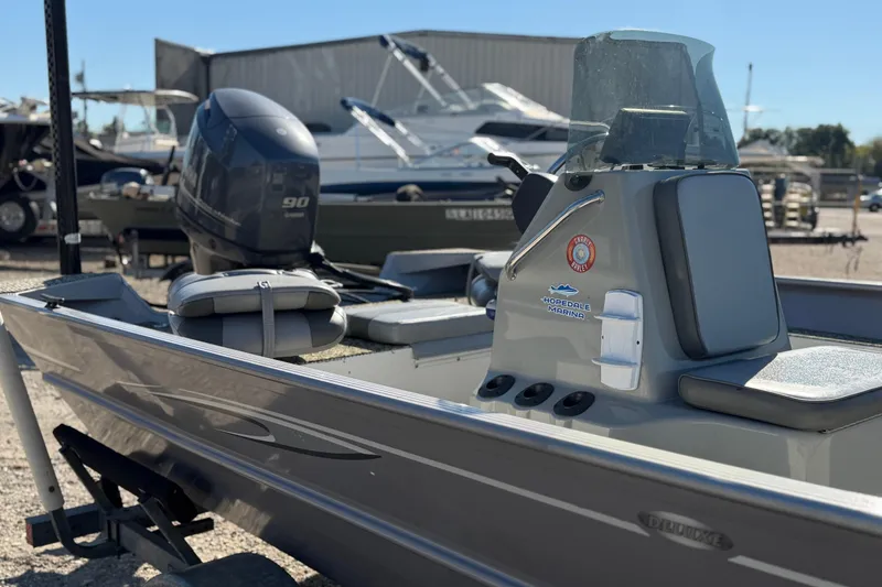 Slide: The Image of 2013 G3 1860 CC Deluxe boat with Yamaha 90 engine, parked at marina. - 11