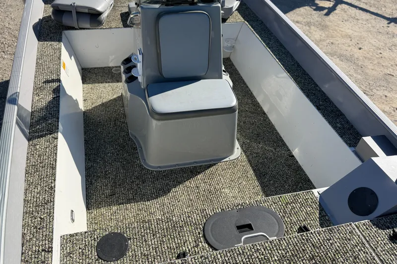 Slide: The Image of 2013 G3 1860 CC Deluxe boat interior with gray seating and textured flooring. - 17