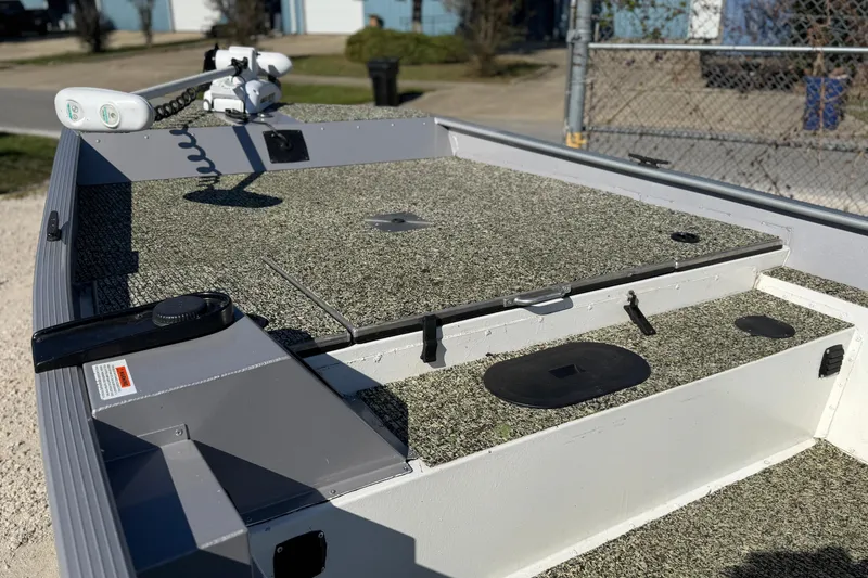 Slide: The Image of 2013 G3 1860 CC Deluxe boat deck with trolling motor and storage compartments. - 19