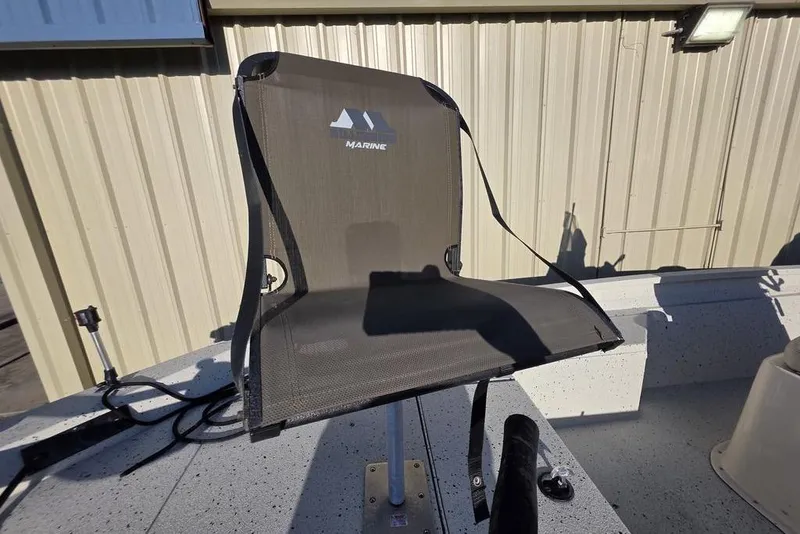 Slide: The Image of 2016 Xpress H20B Bay boat seat with mesh backrest, outdoor setting. - 16