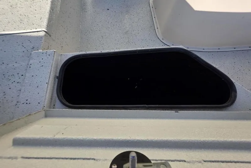 Slide: The Image of 2016 Xpress H20B Bay boat storage compartment with speckled interior. - 17