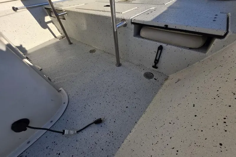 Slide: The Image of 2016 Xpress H20B Bay boat interior with speckled flooring and storage compartments. - 18