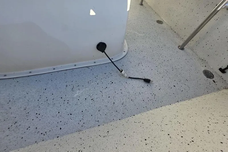 Slide: The Image of 2016 Xpress H20B Bay boat interior with cable on speckled floor. - 21