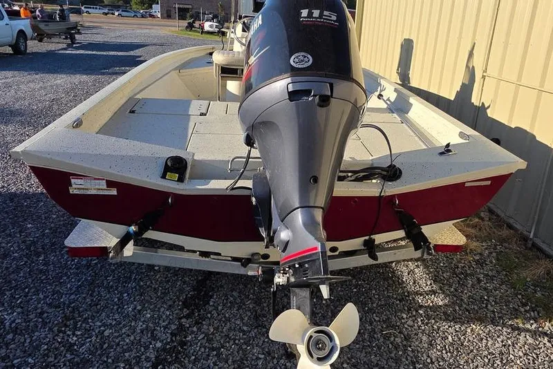 Slide: The Image of 2016 Xpress H20B Bay boat with Yamaha 115 outboard motor, parked on gravel. - 5