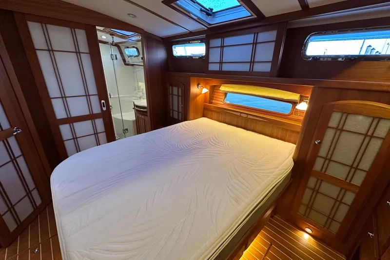 Slide: The Image of Luxurious bedroom interior of 2018 Sabre 48 Flybridge Sedan yacht with wooden accents. - 17