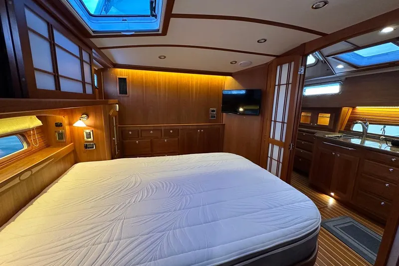 Slide: The Image of Luxurious interior of 2018 Sabre 48 Flybridge Sedan yacht with wood finishes and skylight. - 18