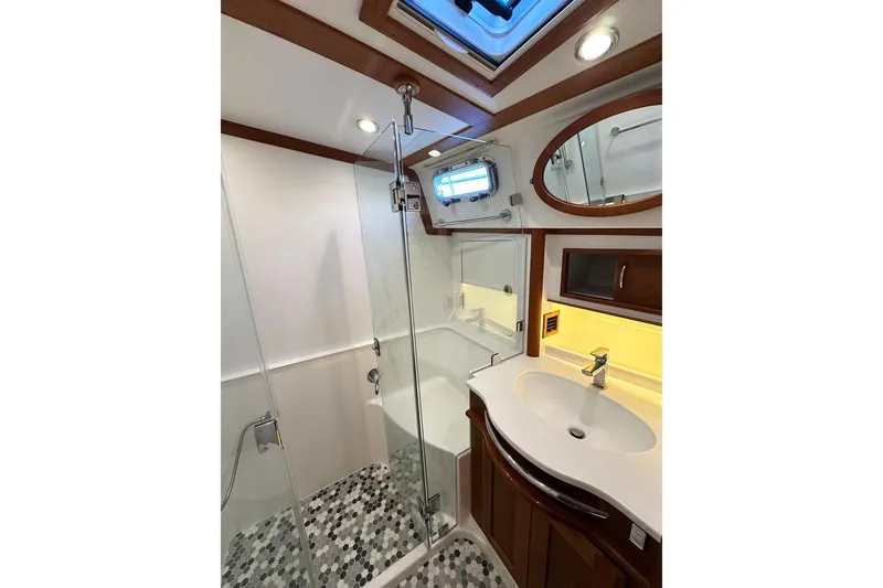 Slide: The Image of Luxurious bathroom in 2018 Sabre 48 Flybridge Sedan yacht with glass shower and modern fixtures. - 19