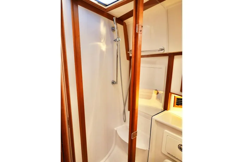 Slide: The Image of 2018 Sabre 48 Flybridge Sedan shower with wooden accents and modern fixtures. - 24