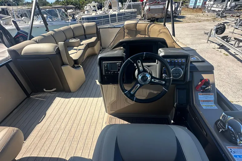 Slide: The Image of 2024 Veranda VP 25RC boat interior with steering wheel and seating area. - 3