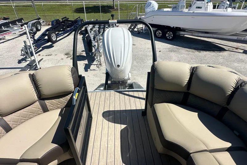 Slide: The Image of 2024 Veranda VP 25RC pontoon boat interior with plush seating and outboard motor. - 7