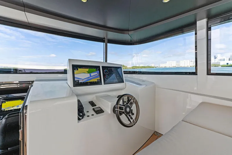Slide: The Image of Modern helm station of 2020 Mangusta 109 yacht with navigation screens and panoramic windows. - 14