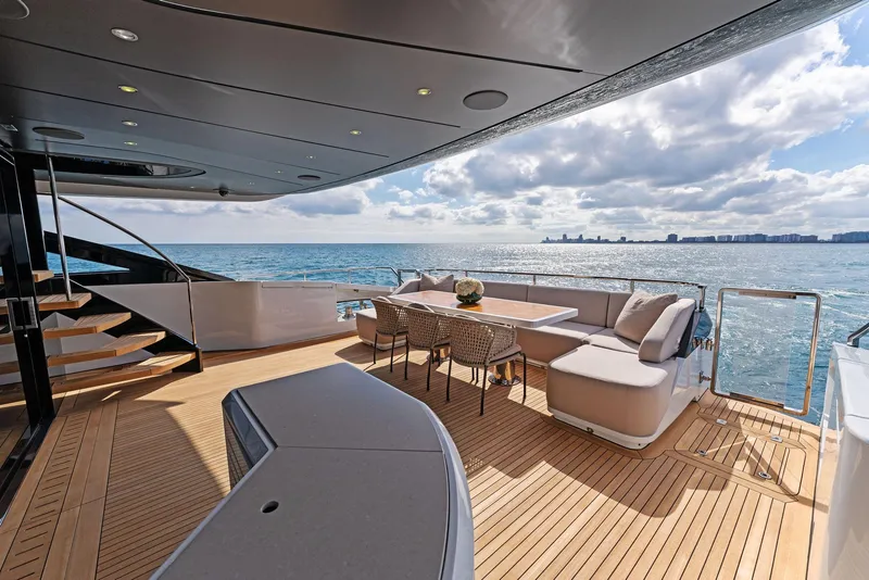 Slide: The Image of Luxurious 2020 Mangusta 109 yacht deck with ocean view, outdoor seating, and dining area. - 17