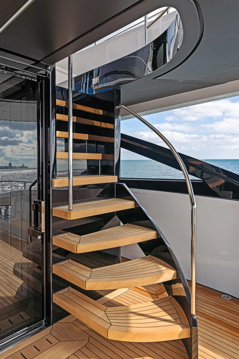 Slide: The Image of Spiral staircase on the 2020 Mangusta 109 yacht with ocean view. - 18